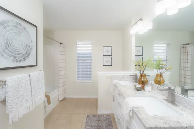 a bathroom with a granite countertop sink a mirror and a shower