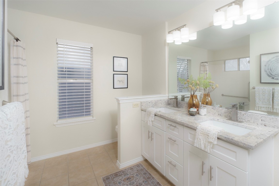 2201 Broughton Court Austin, TX 78727 - Photo 18 of 31 a bathroom with a granite countertop sink and a mirror