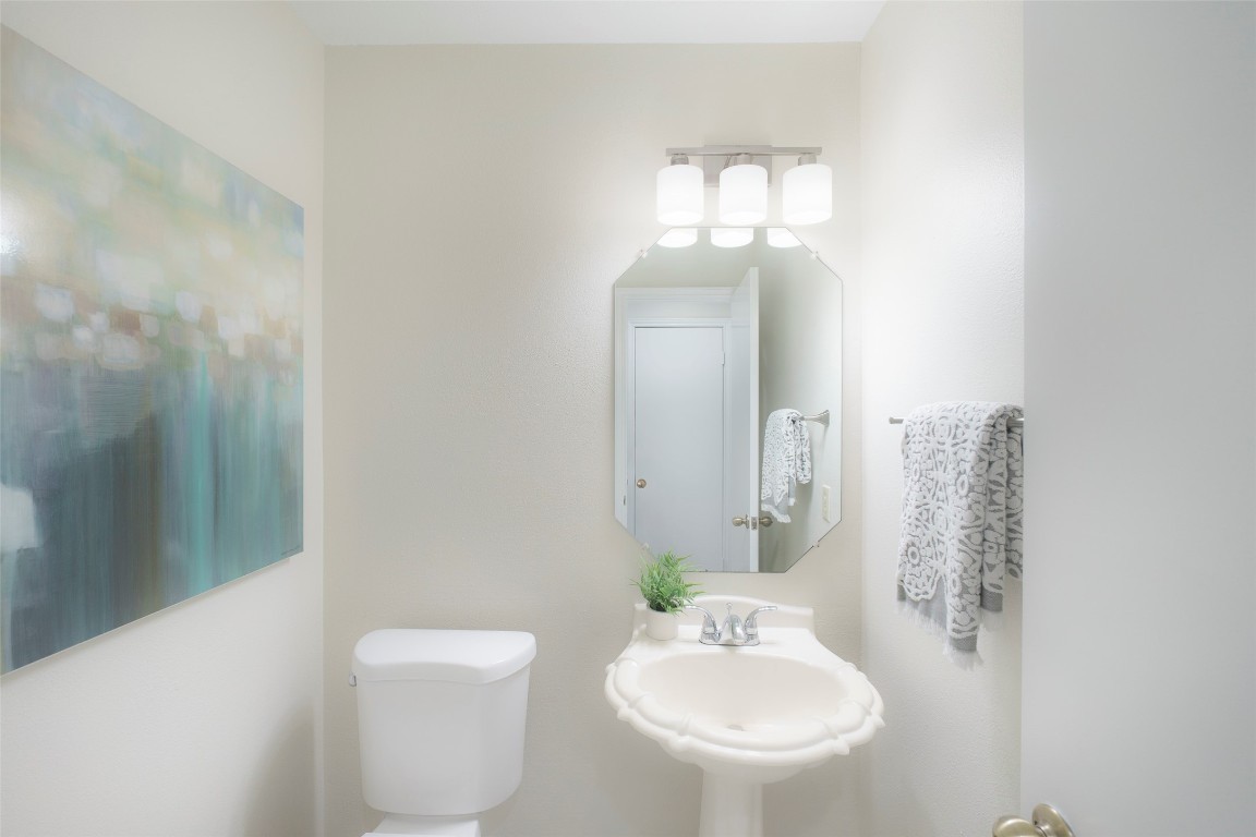 2201 Broughton Court Austin, TX 78727 - Photo 21 of 31 a bathroom with a toilet sink and mirror