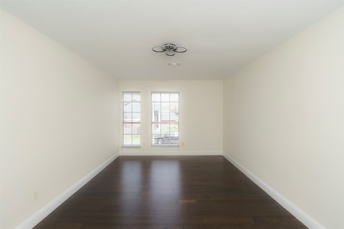 2201 Broughton Court Austin, TX 78727 - Photo 25 of 31 an empty room with wooden floor and windows