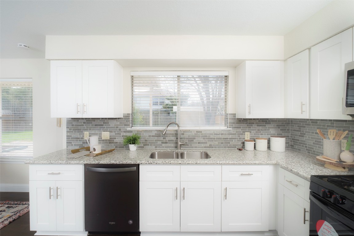 2201 Broughton Court Austin, TX 78727 - Photo 3 of 31 a kitchen with sink a window and cabinets