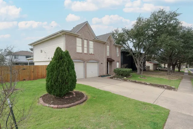 a front view of house with a yard and trees