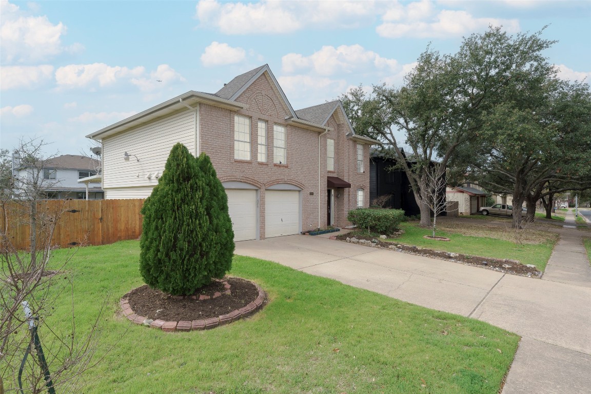 2201 Broughton Court Austin, TX 78727 - Photo 31 of 31 a front view of house with a yard and trees