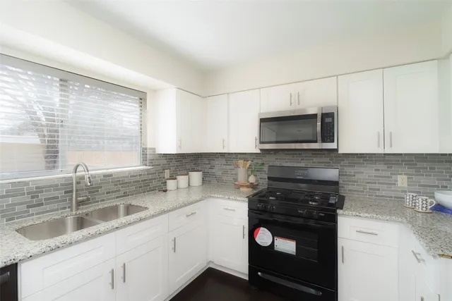 a kitchen with a sink cabinets and stainless steel appliances