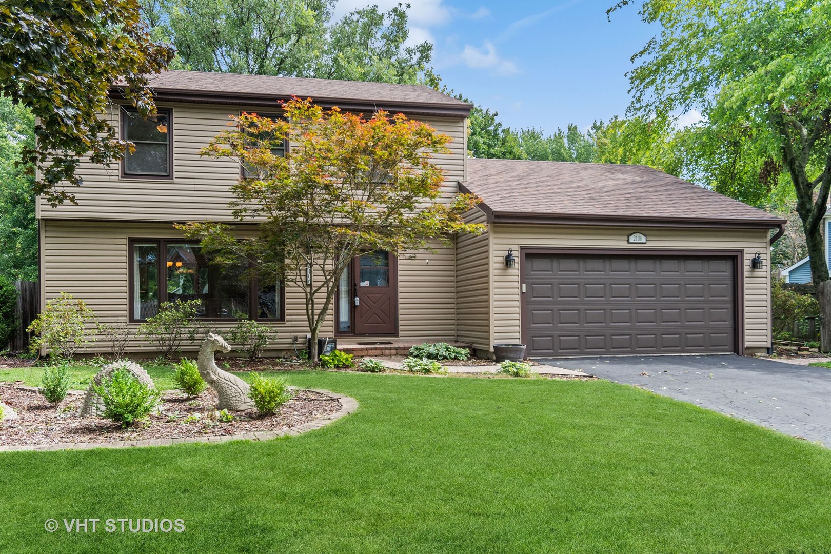 a front view of a house with a yard and garage