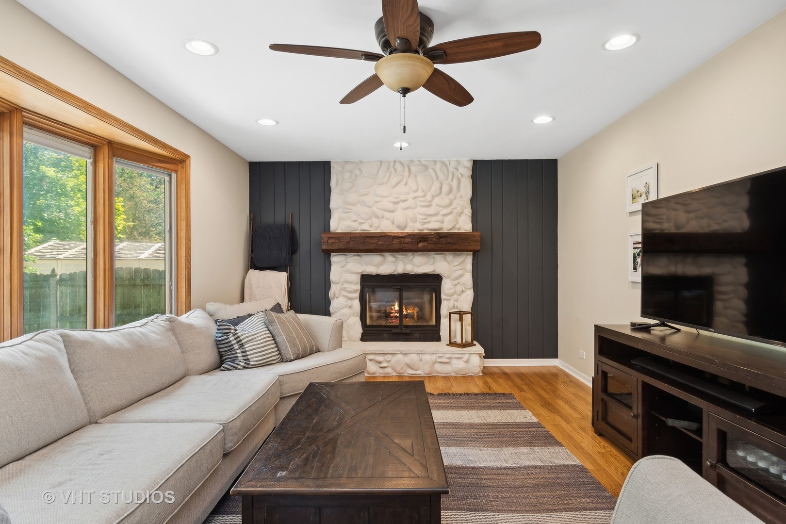 2106 Templar Drive Naperville, IL 60565 - Photo 8 of 17 a living room with furniture a fireplace and a flat screen tv