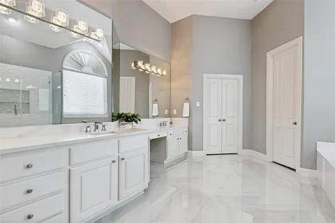 a spacious bathroom with a double vanity sink mirror and