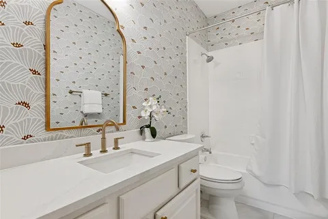 a bathroom with a sink toilet and shower