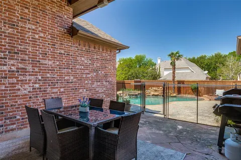 a backyard of a house with table and chairs