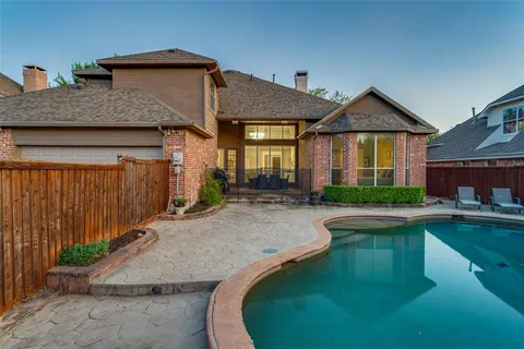 a front view of a house with swimming pool having outdoor seating