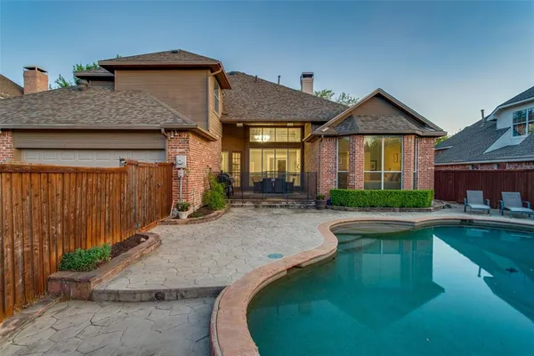 a front view of a house with swimming pool having outdoor seating