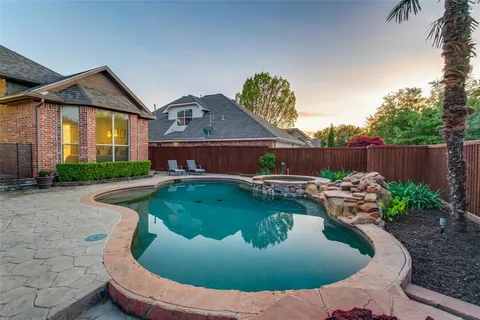 a view of a house with swimming pool and furniture
