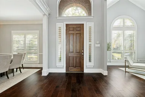a view of a livingroom with furniture wooden floor and a window