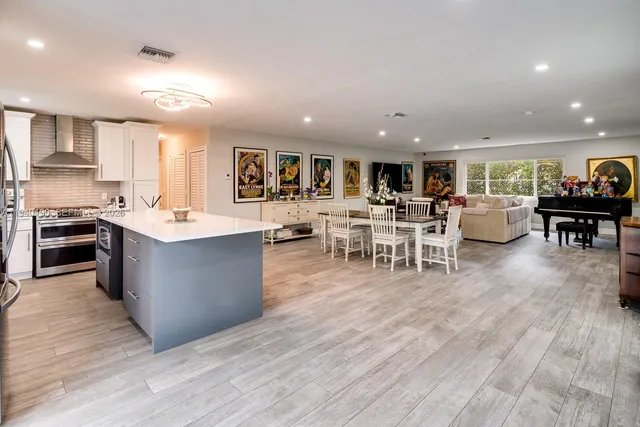 a large kitchen with stainless steel appliances lots of counter space and a wooden floors
