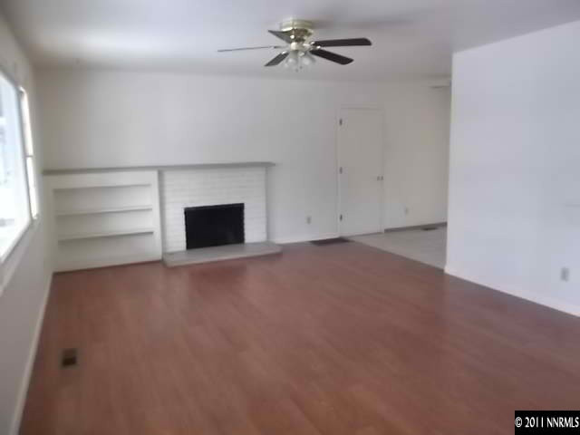 1401 Elizabeth Street Reno, NV 89509 - Photo 3 of 12 an empty room with a fireplace and windows