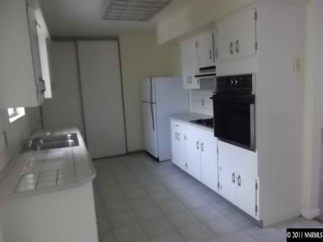 1401 Elizabeth Street Reno, NV 89509 - Photo 5 of 12 a kitchen with cabinets and white appliances