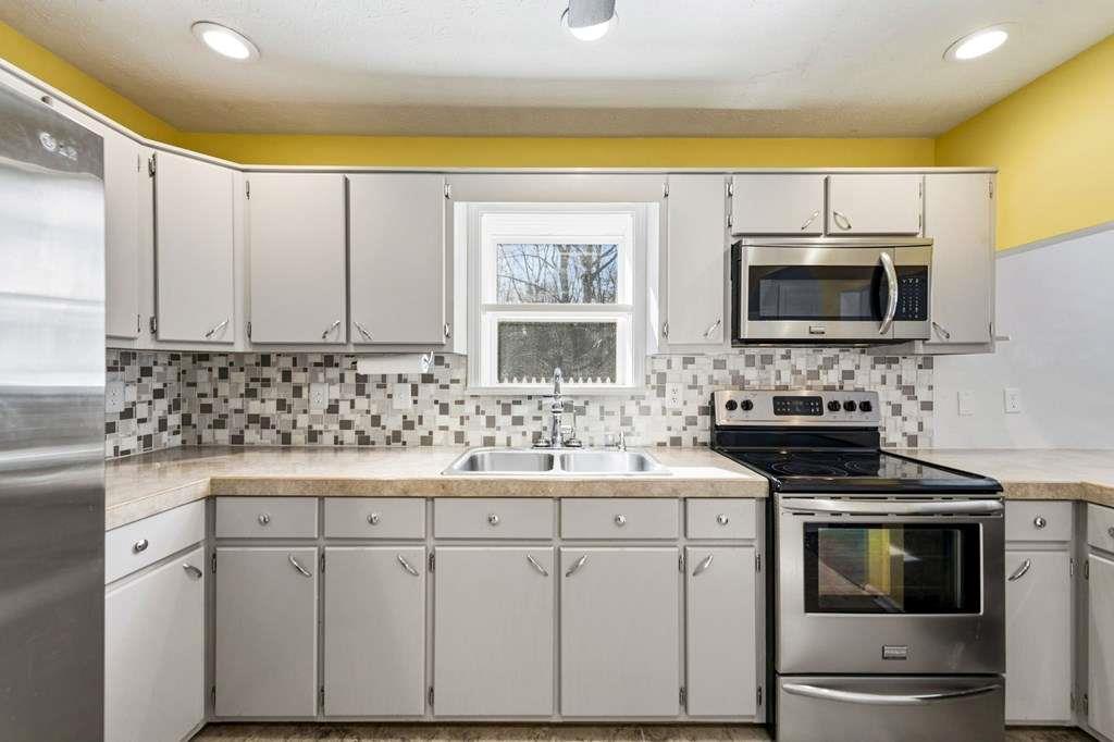 118 Jordan Road Blairsville, GA 30512 - Photo 19 of 49 a kitchen with stainless steel appliances a stove sink and microwave