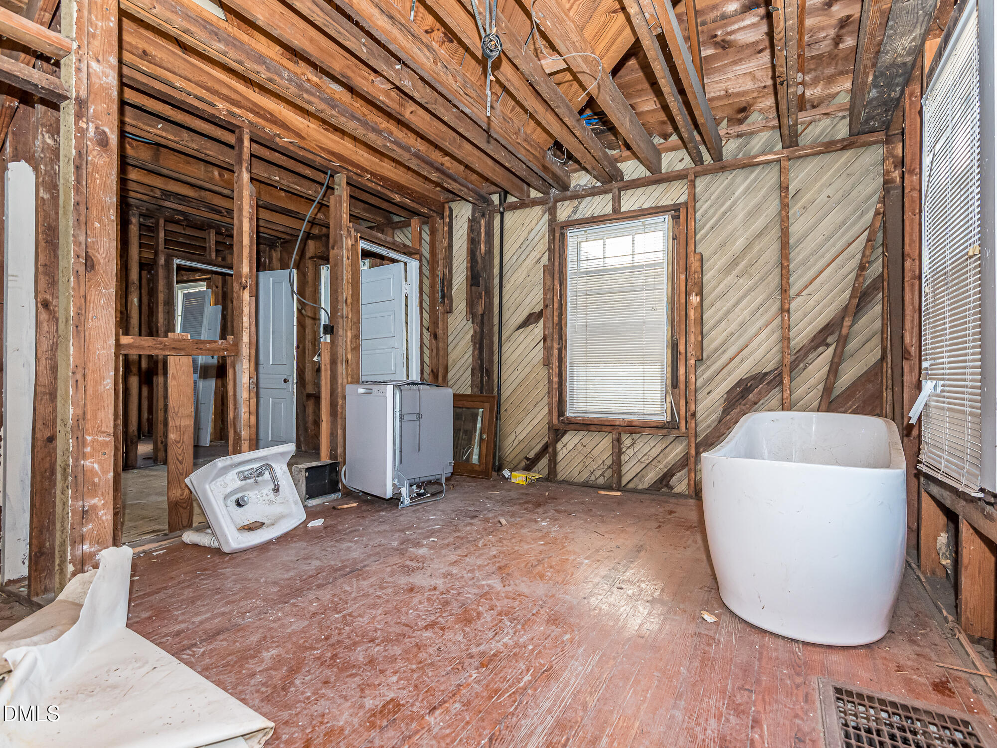 1825 White Oak Road Raleigh, NC 27608 - Photo 25 of 35 a view of an empty room with wooden floor and a window