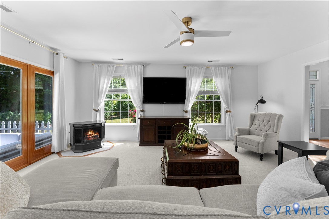 437 Plainview Road Kinsale, VA 22488 - Photo 14 of 63 a living room with furniture a fireplace and a flat screen tv