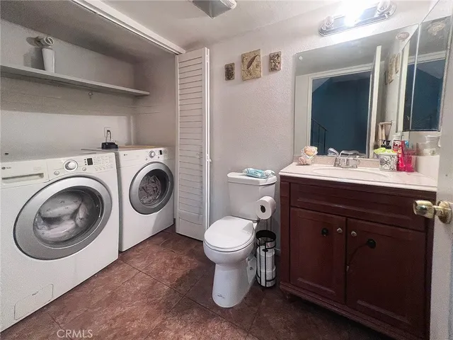 a bathroom with a sink toilet and a mirror