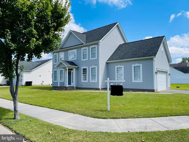 a view of a house with a swimming pool and a yard