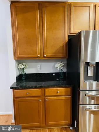 a kitchen with stainless steel appliances granite countertop a refrigerator and a stove