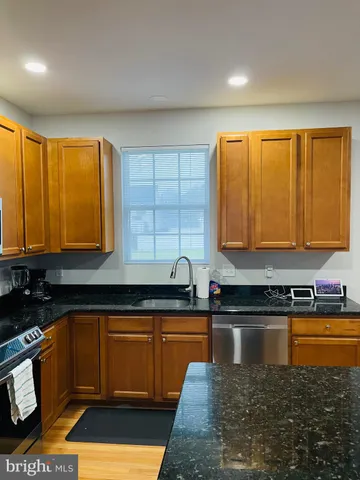 a kitchen with sink a window and cabinets