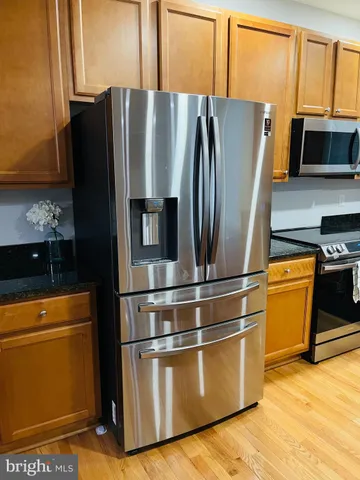 a metallic refrigerator freezer sitting in a kitchen