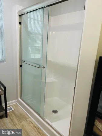 a bathroom with a glass shower door