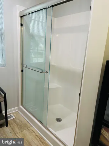 a bathroom with a glass shower door