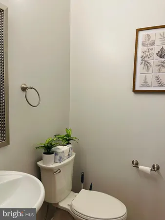 a white toilet sitting next to a bathroom sink