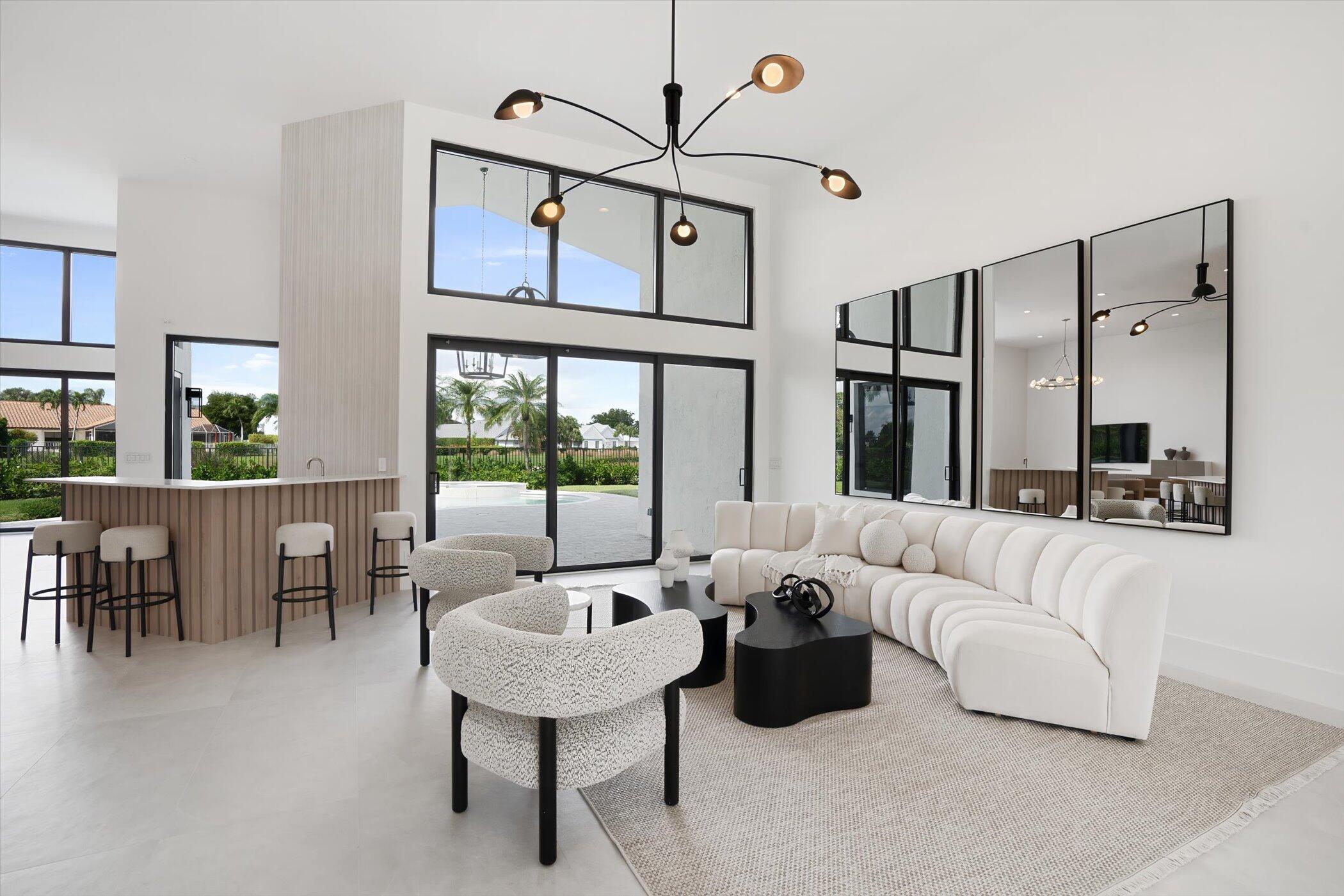 4459 Bocaire Boulevard Boca Raton, FL 33487 - Photo 13 of 72 a living room with furniture ceiling fan and a large window