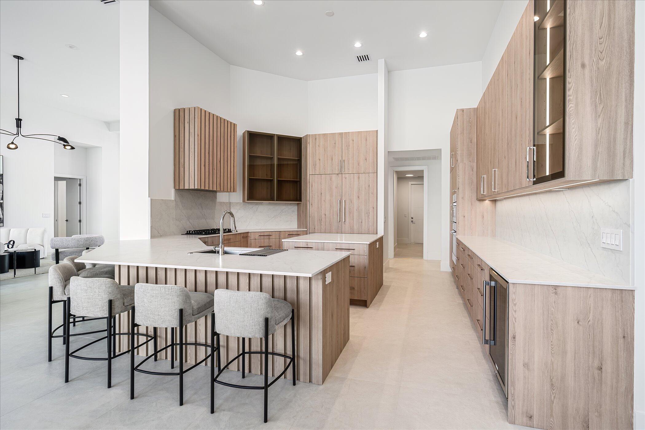 4459 Bocaire Boulevard Boca Raton, FL 33487 - Photo 19 of 72 a large kitchen with a table and chairs