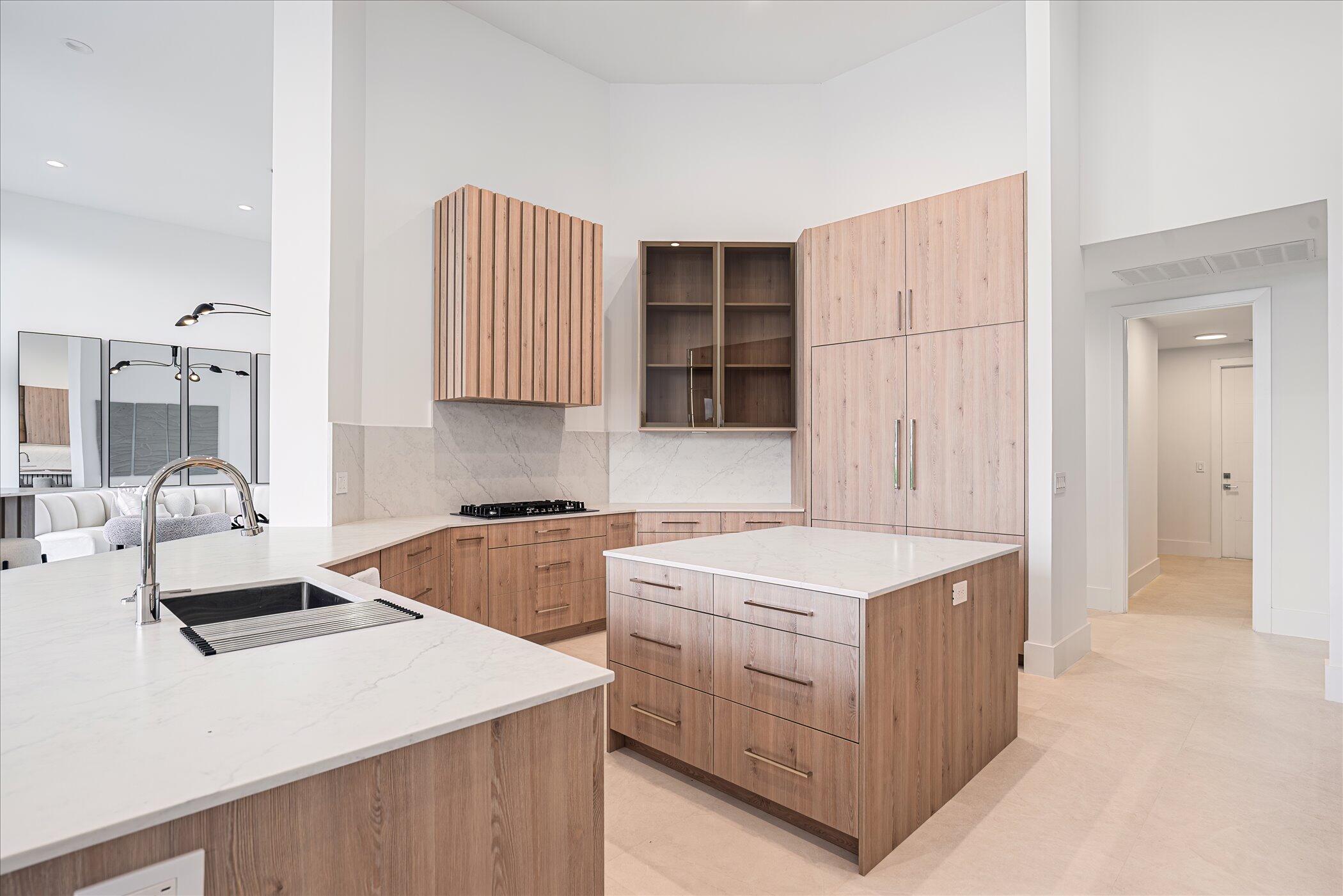 4459 Bocaire Boulevard Boca Raton, FL 33487 - Photo 23 of 72 a kitchen that has a sink and a stove in it