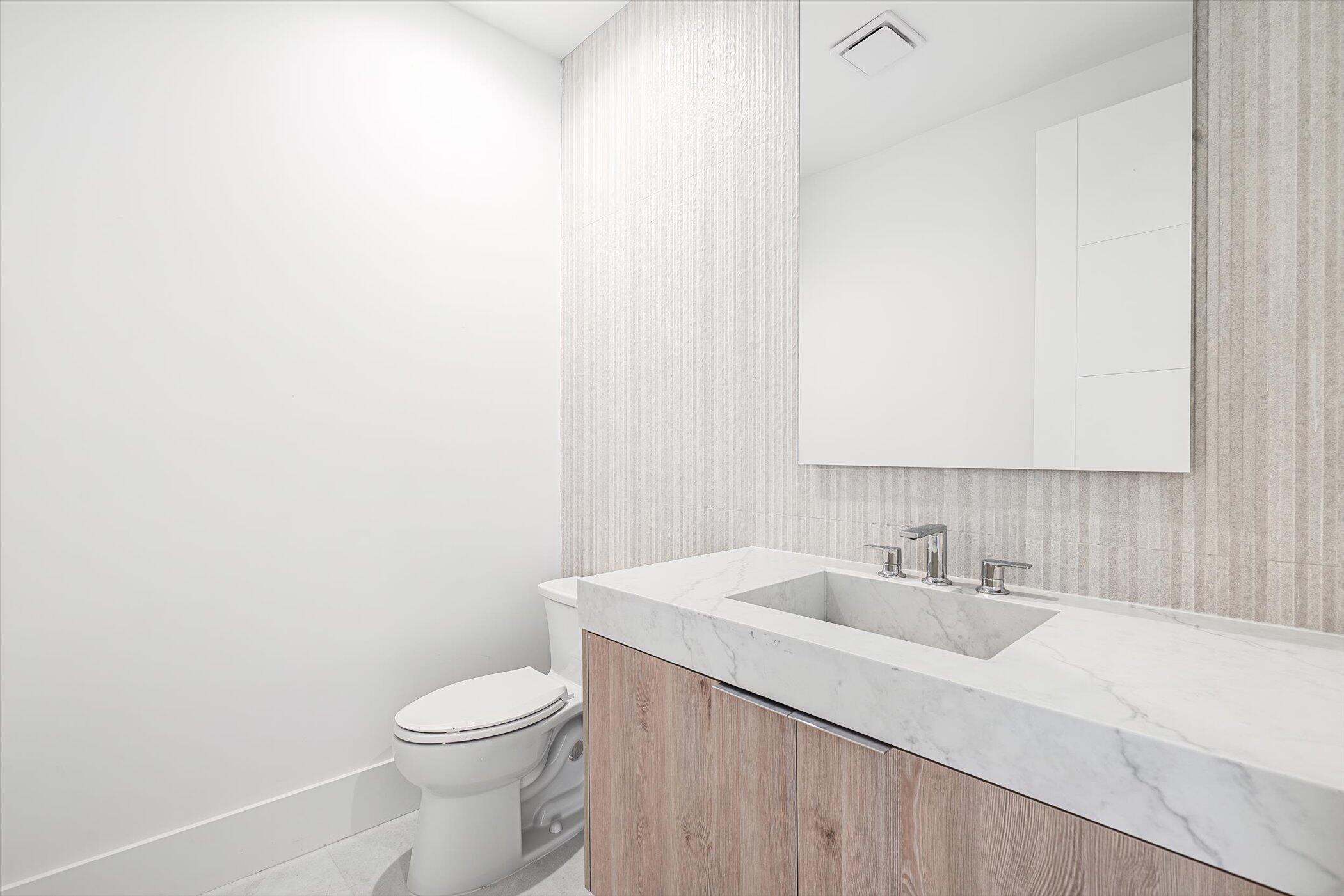 4459 Bocaire Boulevard Boca Raton, FL 33487 - Photo 26 of 72 a bathroom with a sink a toilet and mirror