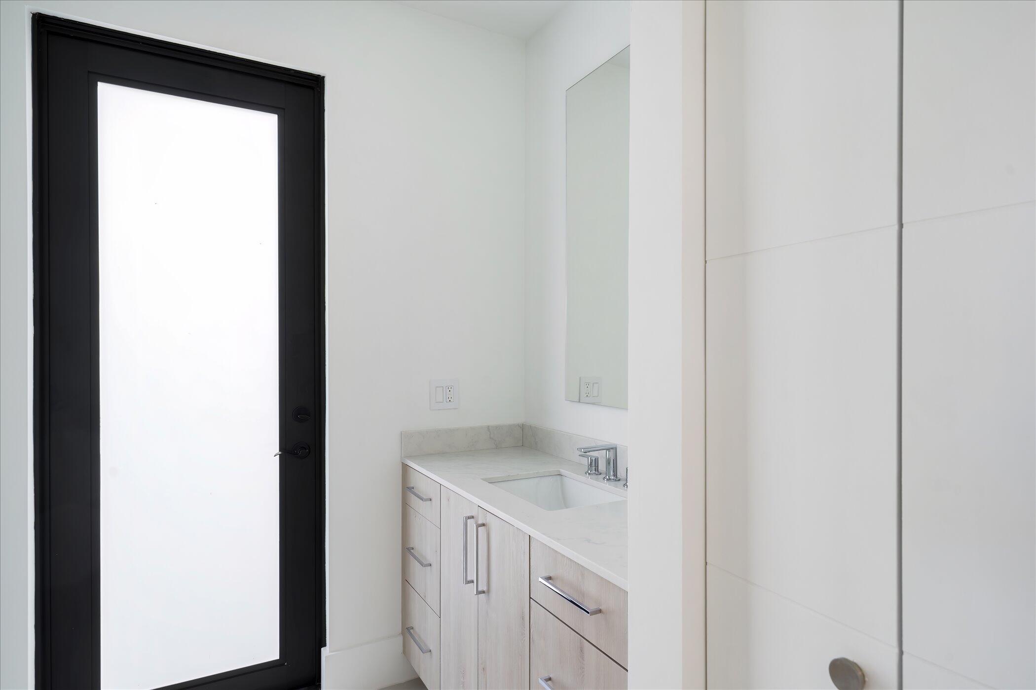 4459 Bocaire Boulevard Boca Raton, FL 33487 - Photo 30 of 72 a room with a sink and a mirror