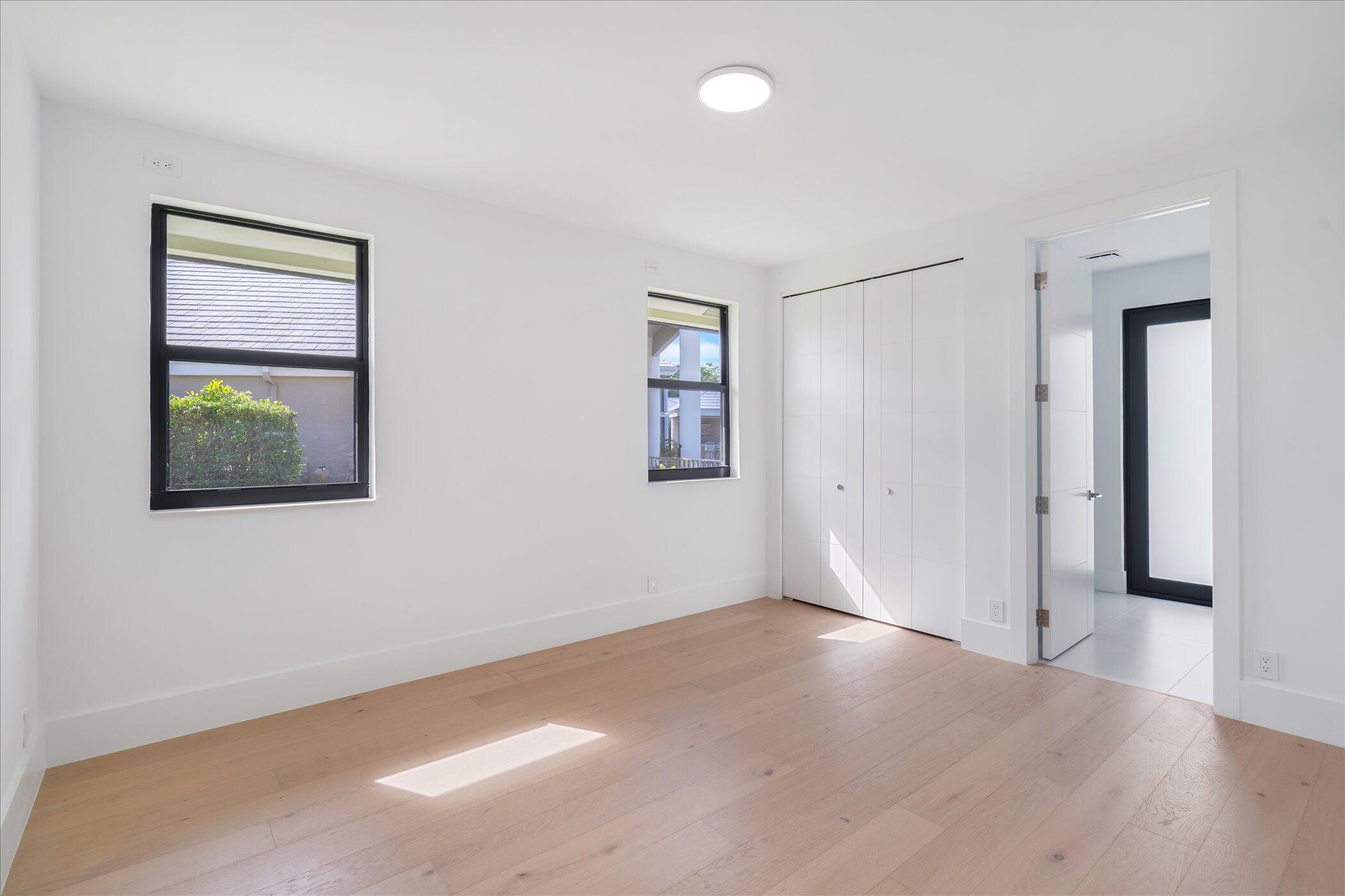 4459 Bocaire Boulevard Boca Raton, FL 33487 - Photo 34 of 72 a view of an empty room with a window and wooden floor