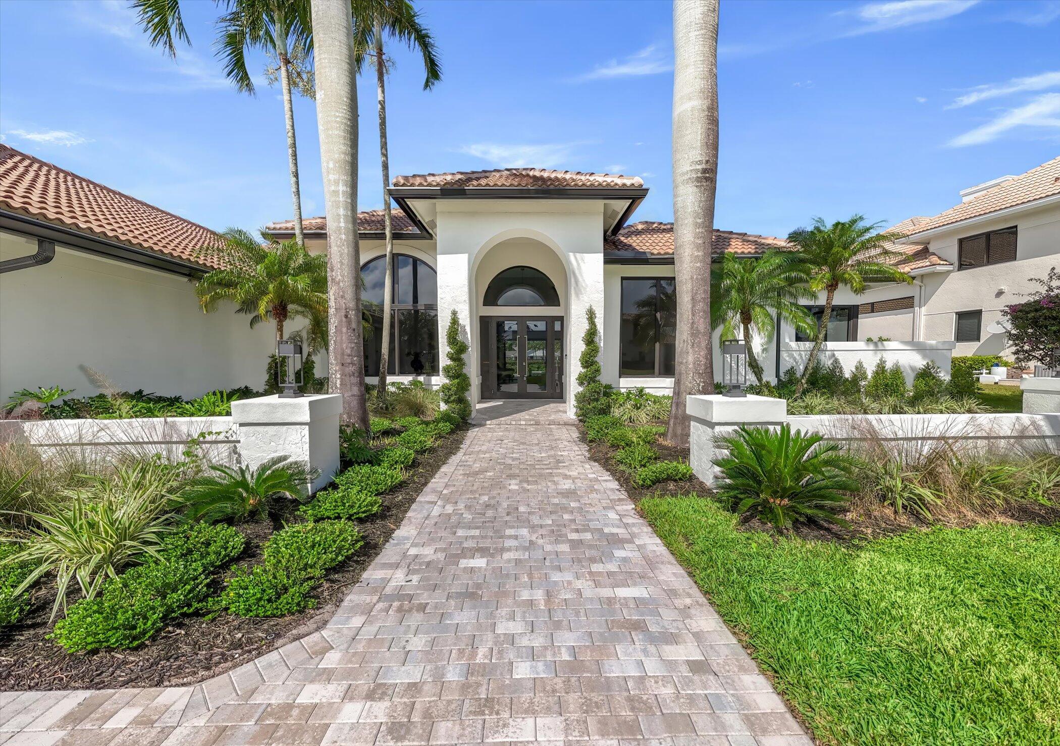 4459 Bocaire Boulevard Boca Raton, FL 33487 - Photo 50 of 72 a front view of a house with a garden and plants