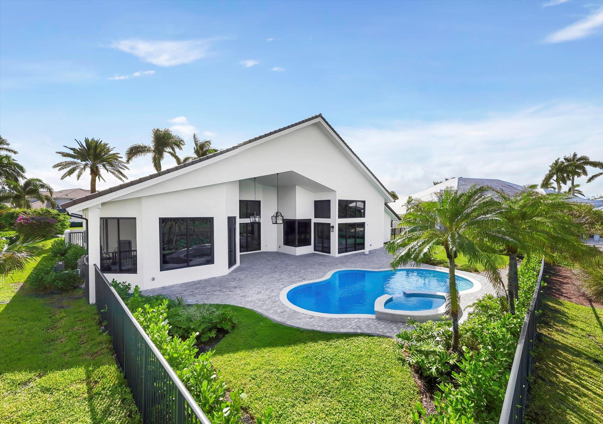 4459 Bocaire Boulevard Boca Raton, FL 33487 - Photo 53 of 72 a front view of house with yard and outdoor seating