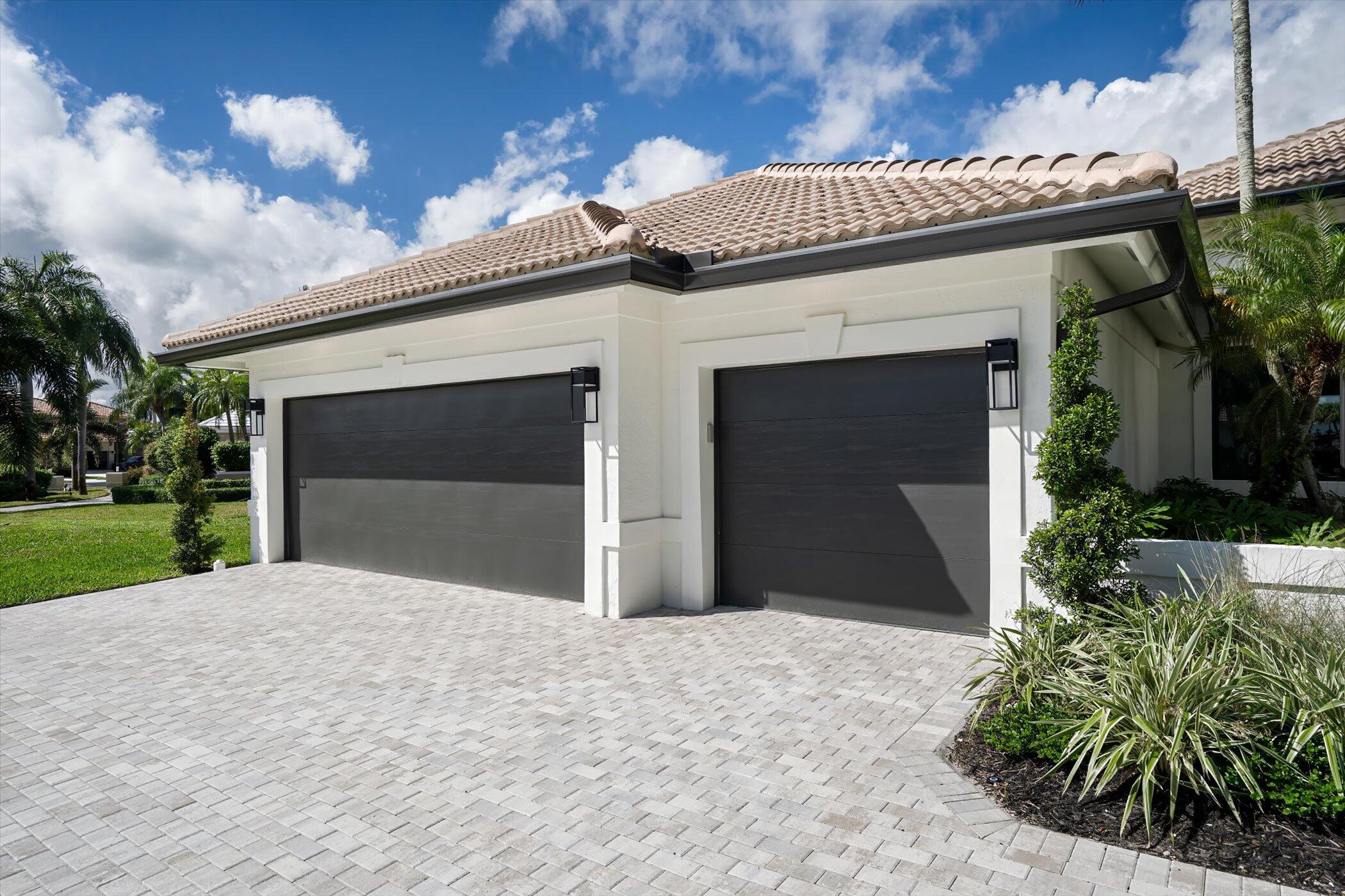 4459 Bocaire Boulevard Boca Raton, FL 33487 - Photo 7 of 72 a front view of a house with a yard and garage