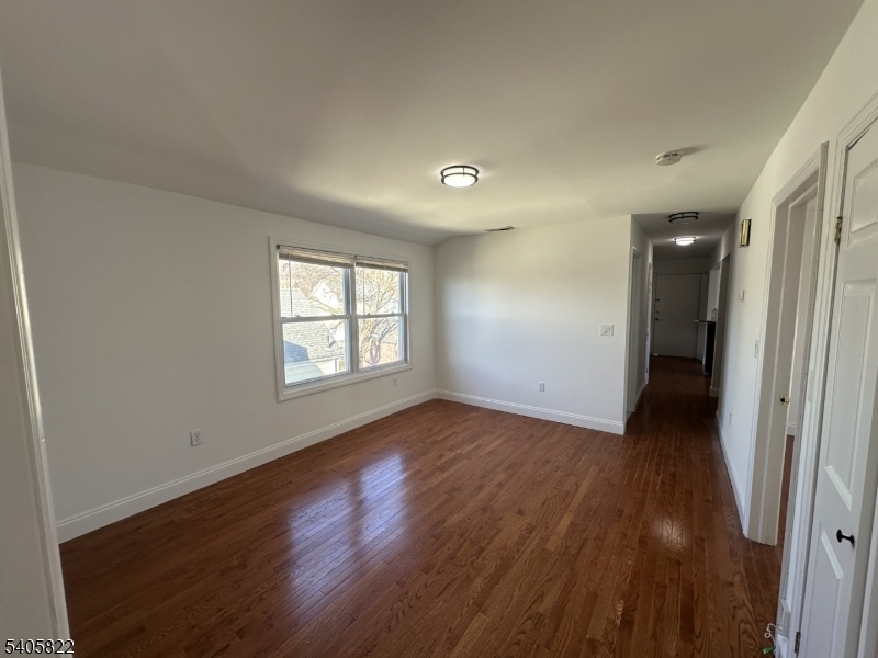 26 Van Rensselear Street, Unit 3 Belleville, NJ 07109 - Photo 1 of 12 an empty room with wooden floor and windows