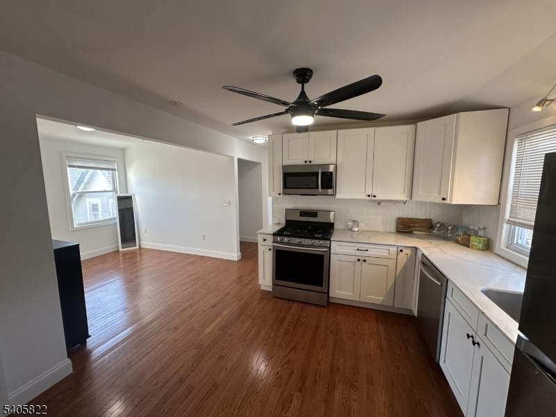 26 Van Rensselear Street, Unit 3 Belleville, NJ 07109 - Photo 11 of 12 a kitchen with a stove a sink and a refrigerator