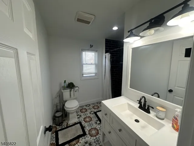 a bathroom with a sink toilet and mirror