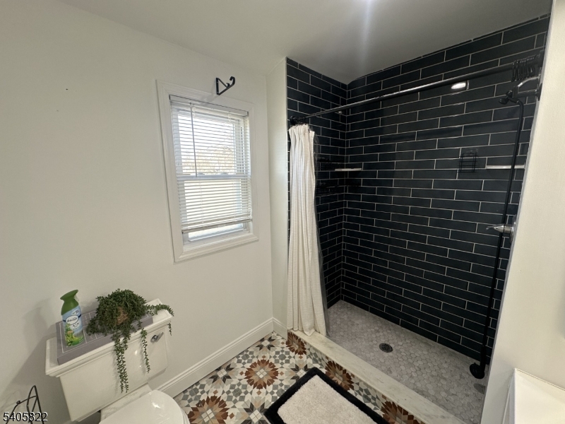 26 Van Rensselear Street, Unit 3 Belleville, NJ 07109 - Photo 8 of 12 a bathroom with a bathtub and a shower