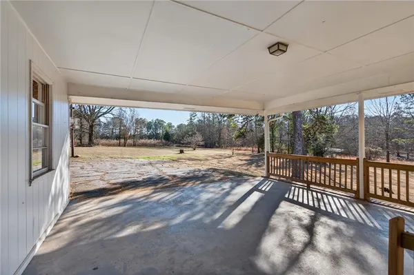 a view of a house with backyard and a tree