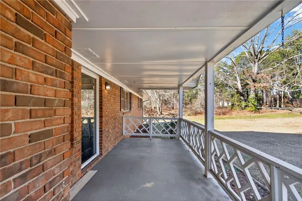 a view of a porch with wooden floor and outdoor space