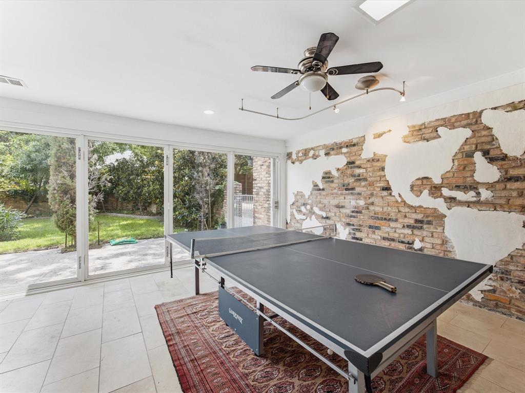 6160 Spring Valley Road Dallas, TX 75240 - Photo 21 of 40 Expansive multi-pane glass doors open to a private yard with lush greenery