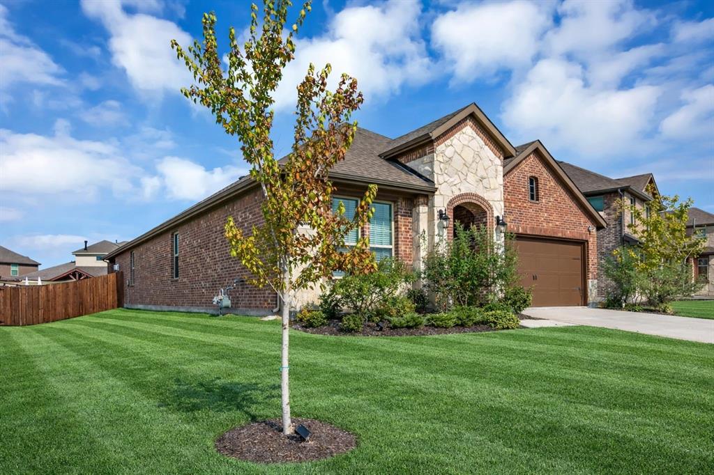 3106 Maverick Drive Forney, TX 75126 - Photo 2 of 32 a front view of a house with a yard and garage