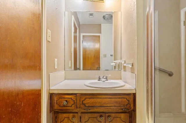 a bathroom with a sink and a mirror