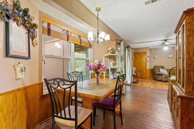 a dining room with furniture and wooden floor
